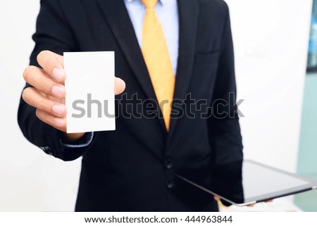 Businessman holding and showing blank business card isolate on white background.
