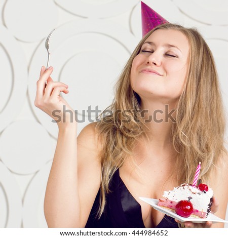 beautiful caucasian girl blowing candles on her cake