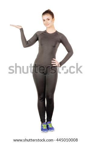 Portrait of young fitness instructor  showing open hand palm with copy space for product or text. human emotion expression and lifestyle concept. image on a white studio background.