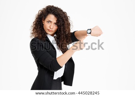Young tender curly girl looking at watch over white background Royalty-Free Stock Photo #445028245