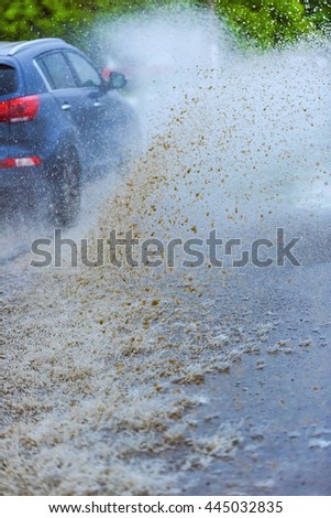 motion car rain big puddle of water spray from the wheels
