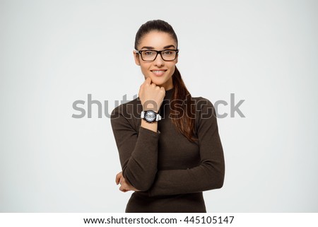 Tender girl wearing glasses showing her watch.