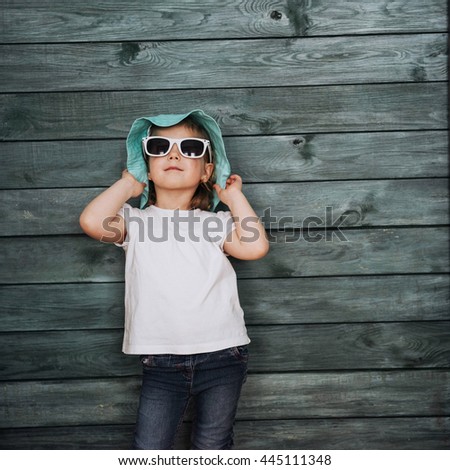 Fashion little girl, a child dressed in the fashion and sunglasses. Posing for the camera