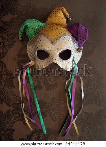 photo of a carnival mask on decorative fabric