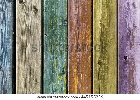 backgrounds and texture concept - old wooden fence painted in different colors background