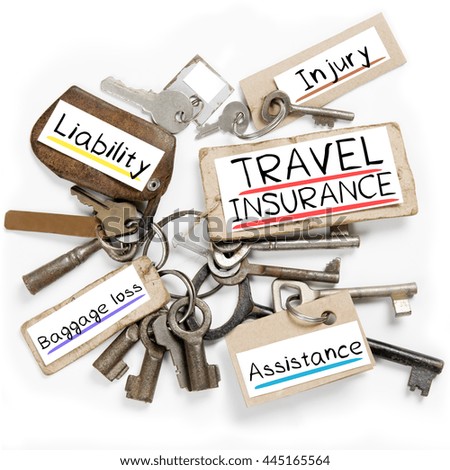 Photo of key bunch and paper tags with TRAVEL INSURANCE conceptual words
