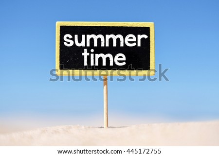 Text Summer time written with chalk on chalkboard. Text Summer time written with chalk on chalkboard, on sandy beach side 