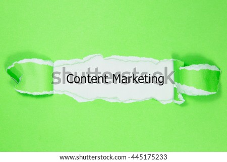 The text Content Marketing appearing behind torn paper. 