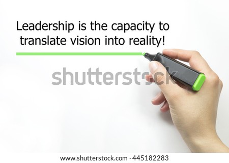 Hand writing "Leadership is the capacity to translate vision into reality" with marker on isolated on white
