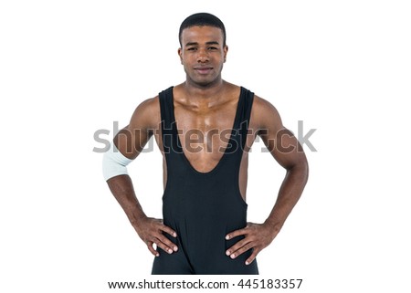 Athlete standing with hand on hip on white background