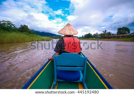  Tourist take a photo by smartphone in a boat on Nam Song River at Vang Vieng Lao.Soft focus. 
