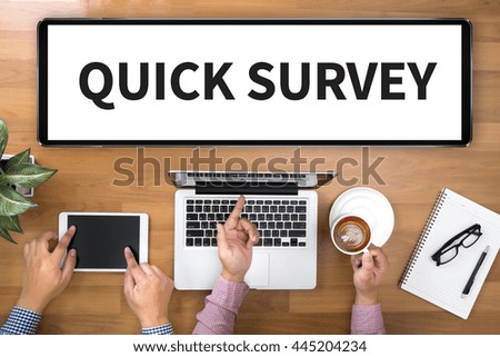 QUICK SURVEY              Two Businessman working at office desk and using a digital touch screen tablet and use computer, top view