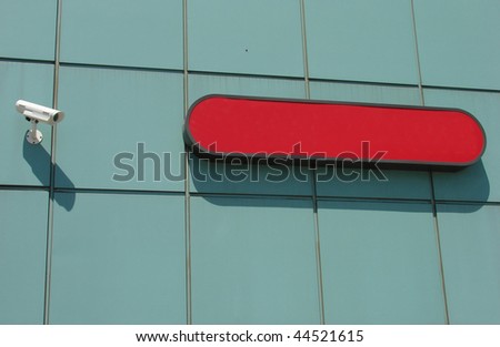 blank red sign with security camera
