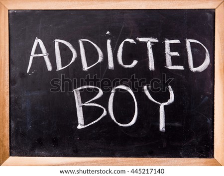 addicted boy  word on blackboard