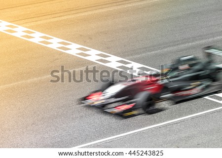 Motion blur, Race car racing on race track with start and finish line. Royalty-Free Stock Photo #445243825