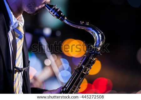 saxophone player with bokeh background Royalty-Free Stock Photo #445272508