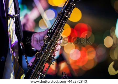saxophone player with bokeh background Royalty-Free Stock Photo #445272943