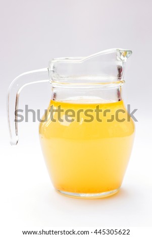 Glass jug of chicken broth isolated on white background