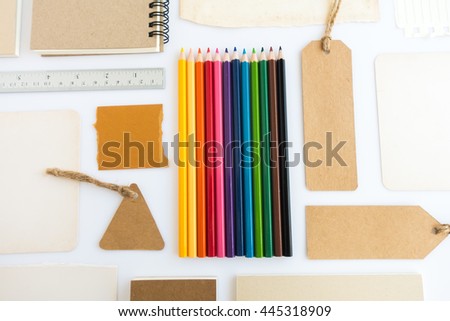 Collection of various paper, cardboard, tag, card, book and colour pencils with soft shadows.