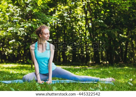 Yoga woman on green park background. 