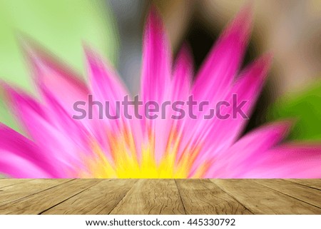 Empty wooden table on blurred lotus flowers background