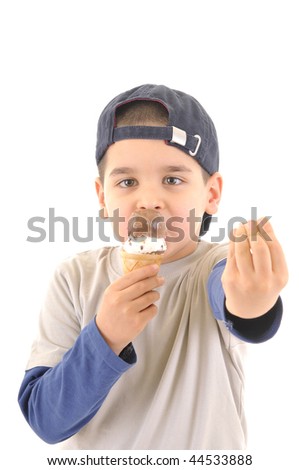 Cute boy licking assorted ice cream in sugar cone.  White background vertical high resolution studio image.