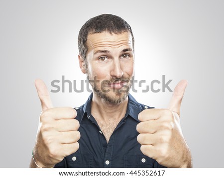 portrait of a smiling young man with thumbs up