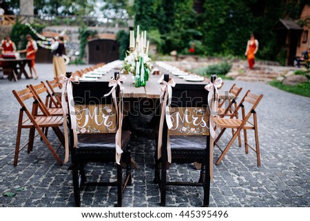 Wedding. Banquet. Honeymoon chairs with wooden signs "Mr" and "Mrs"
