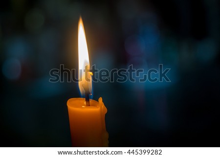 One light candle burning brightly with bokeh background Royalty-Free Stock Photo #445399282