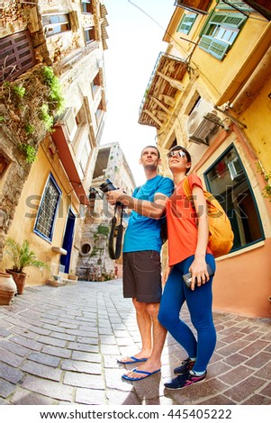 couple tourists walking in the old town. tourists considering the narrow streets of the city, happy and surprised