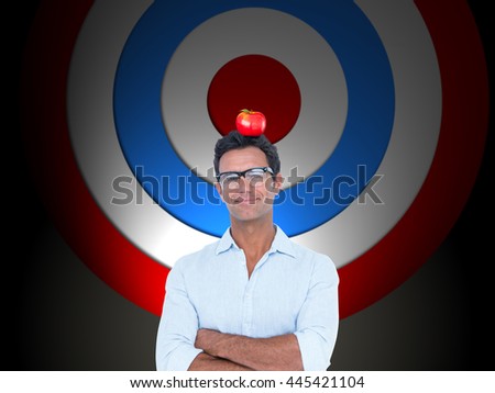 Confident man standing with arms crossed against red and blue target