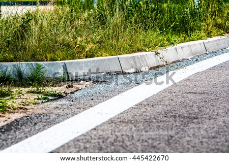 asphalt road with painted white line separates the road from the shoulder