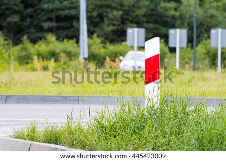 sign cone white red green grass road