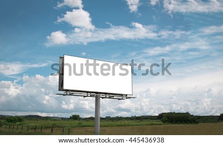 Empty billboard in front of beautiful cloudy sky in a rural location Royalty-Free Stock Photo #445436938