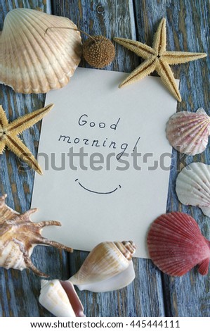 "Good morning" is written on small paper with seashells
