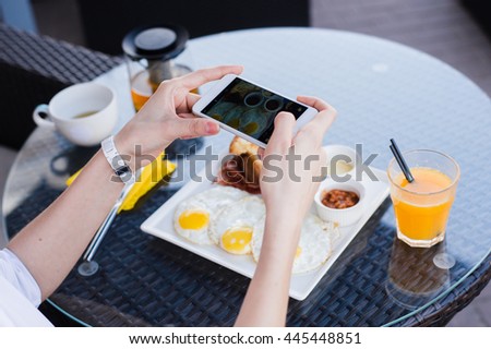 Woman hands taking food photo by mobile phone. Food photography. Delicious breakfast.