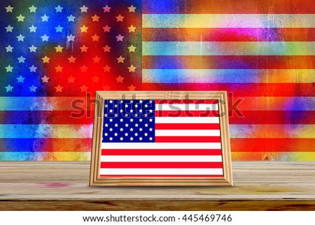USA flag in photo frames on wooden table