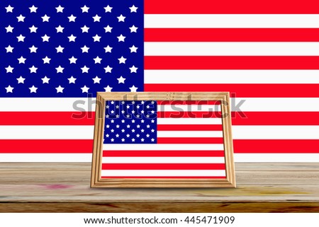 American flag in photo frames on wooden table
