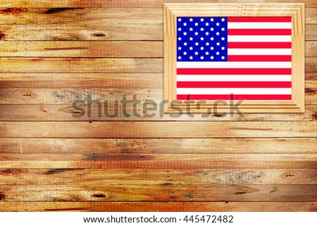 USA flag in photo frames on wooden table,wooden wall background