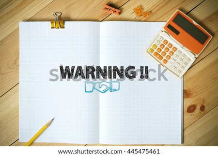 WARNING  TEXT on paper in the office , business analysis and strategy as concept
