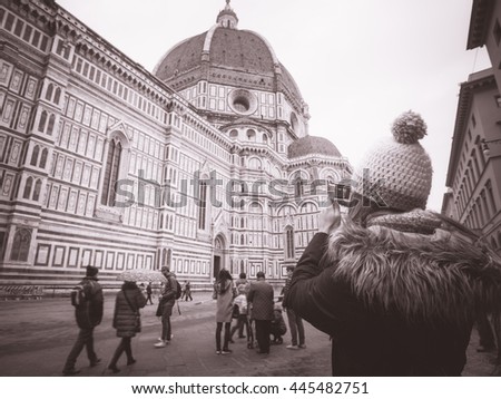 monochrome woman with hat taking pictures in Florence Italy