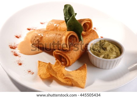 Rolls with meat sauce and guacamole on plate