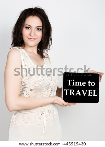 technology, internet and networking - close-up successful woman holding a tablet pc with time to travel sign. internet technology in tourism
