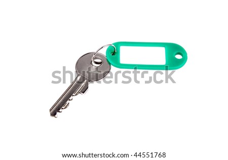 Blank green key tag and door key over white background
