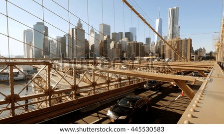 cars crossing bridge. new york city skyline cityscape background. traffic transportation scene