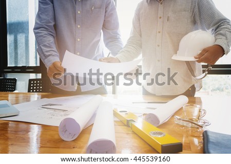 Architects concept, Architects working with blueprints in the office Royalty-Free Stock Photo #445539160