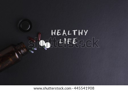 HEALTHY LIFE word with medicine and bottle - Health concept. Medical conceptual