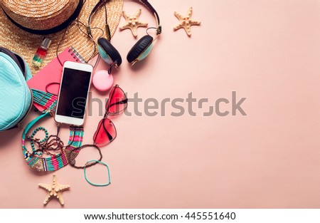  Top view of essential modern young lady or girl on vacations.Woman's summer holidays accessories composed on pastel color background. Beach fashion , summer concept. Trendy colors. Royalty-Free Stock Photo #445551640