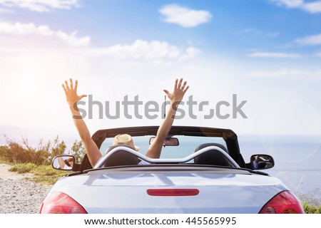 Young men drive a car on the beach. Royalty-Free Stock Photo #445565995