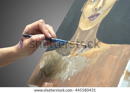 artist paints picture on canvas